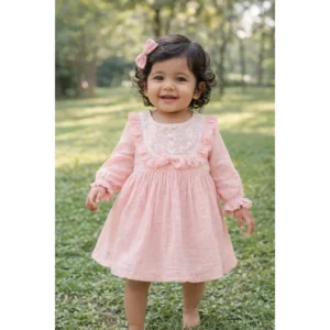 Baby girl wearing blush pink muslin lace dress soft cotton outfit for infants